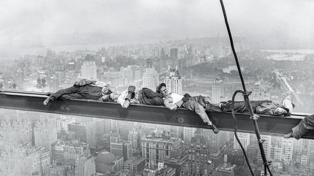 Black-and-white photo of construction workers taking a break in the air – teacher tiredness afternoon lull body clocks