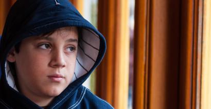 Schoolboy, looking mournfully into the distance