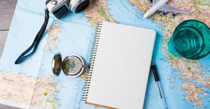 Map on a table with a notebook, pen and camera, improving map skills