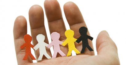 Hand Holding Row Of Paper People To Illustrate Safeguarding In Schools